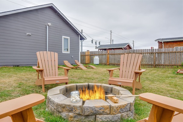 Backyard fire pit with 4 Adirondacks.  Wood is not guaranteed.