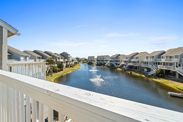 Primary bedroom balcony overlooks pond/fountain