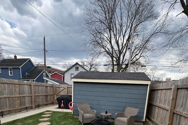 Cozy backyard retreat featuring a fire pit with comfortable outdoor seating—perfect for evening conversations and relaxing under the stars.