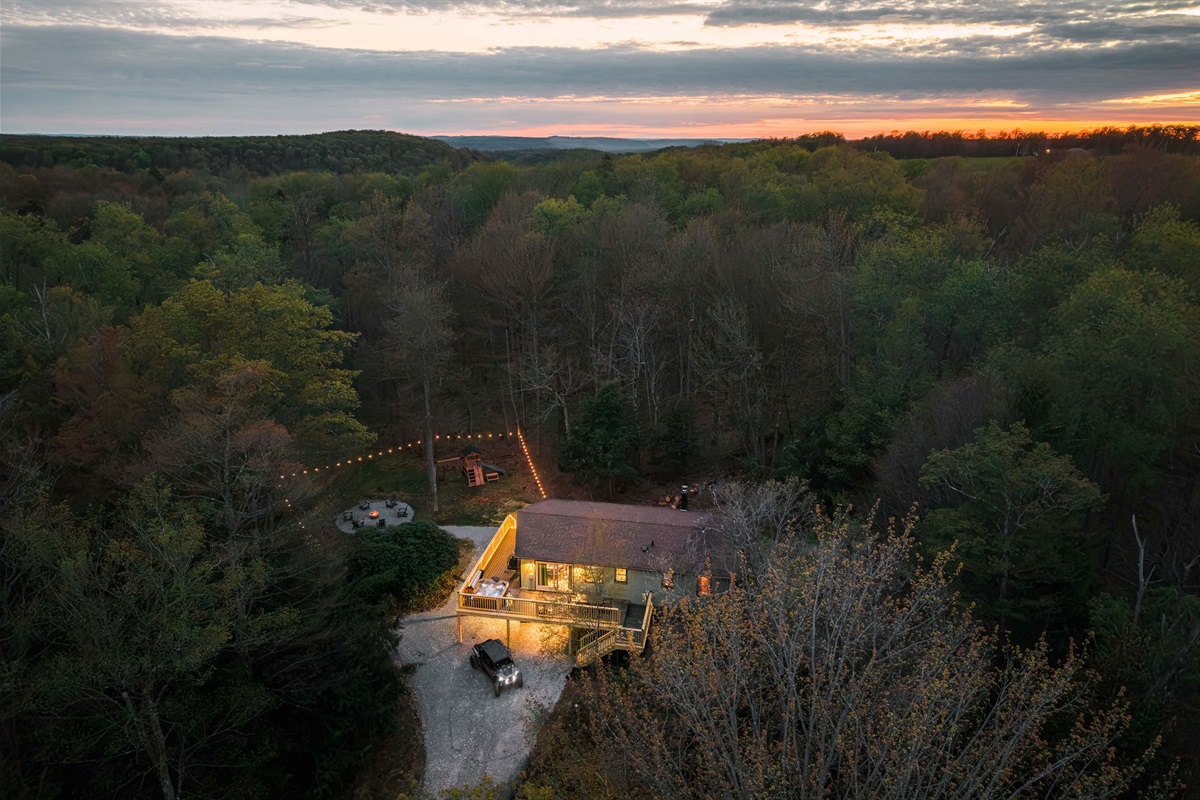 🏡 The cabin aglow beneath a fiery sky.