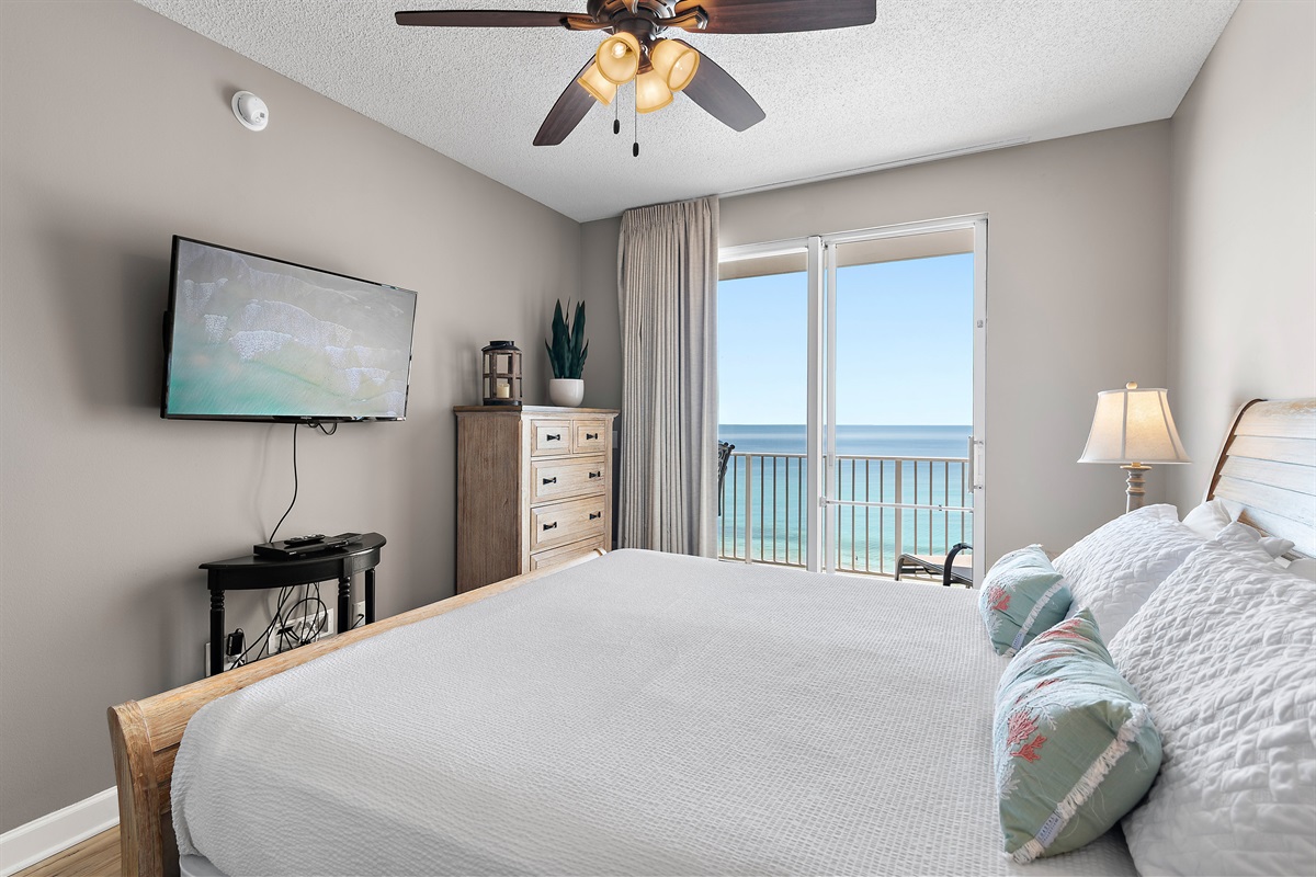 Spacious master bedroom features a King bed, Gulf views, balcony access, SMART TV w/ cable access, bathroom with dual vanity and shower/tub combo, and large closet.