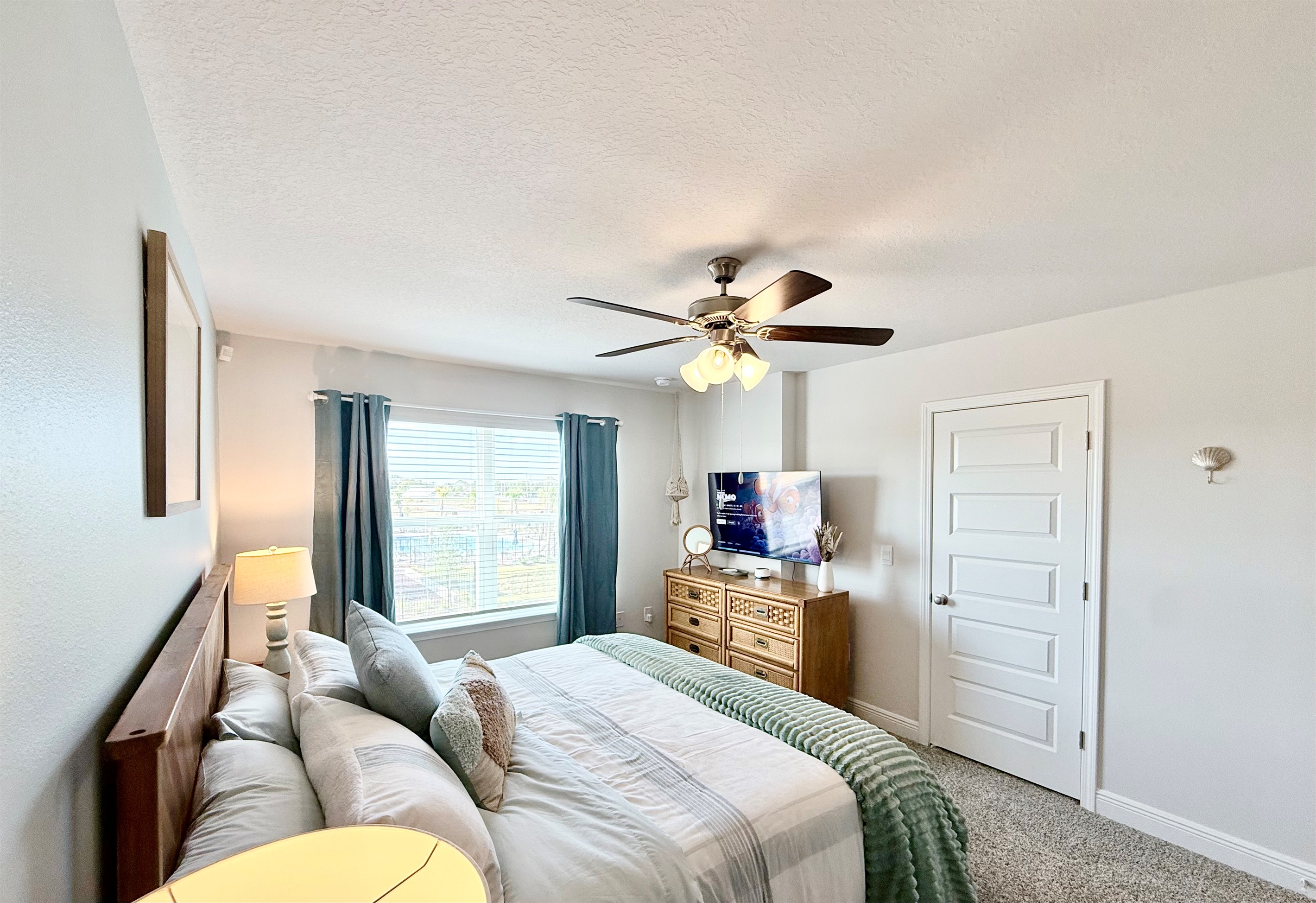 The spacious primary king bedroom featuring a 50" 4K HDR Smart TV and walk-in closet