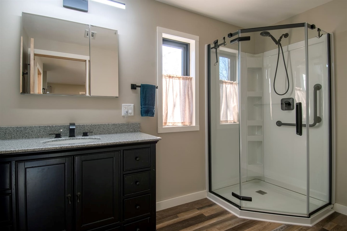 Guest Quarters bathroom has grab bars in the walk-in shower.