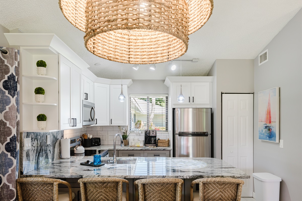 Bright open-concept living with dining for 6 and a fully upgraded kitchen featuring modern finishes, breakfast bar seating, and everything you need to cook and entertain
