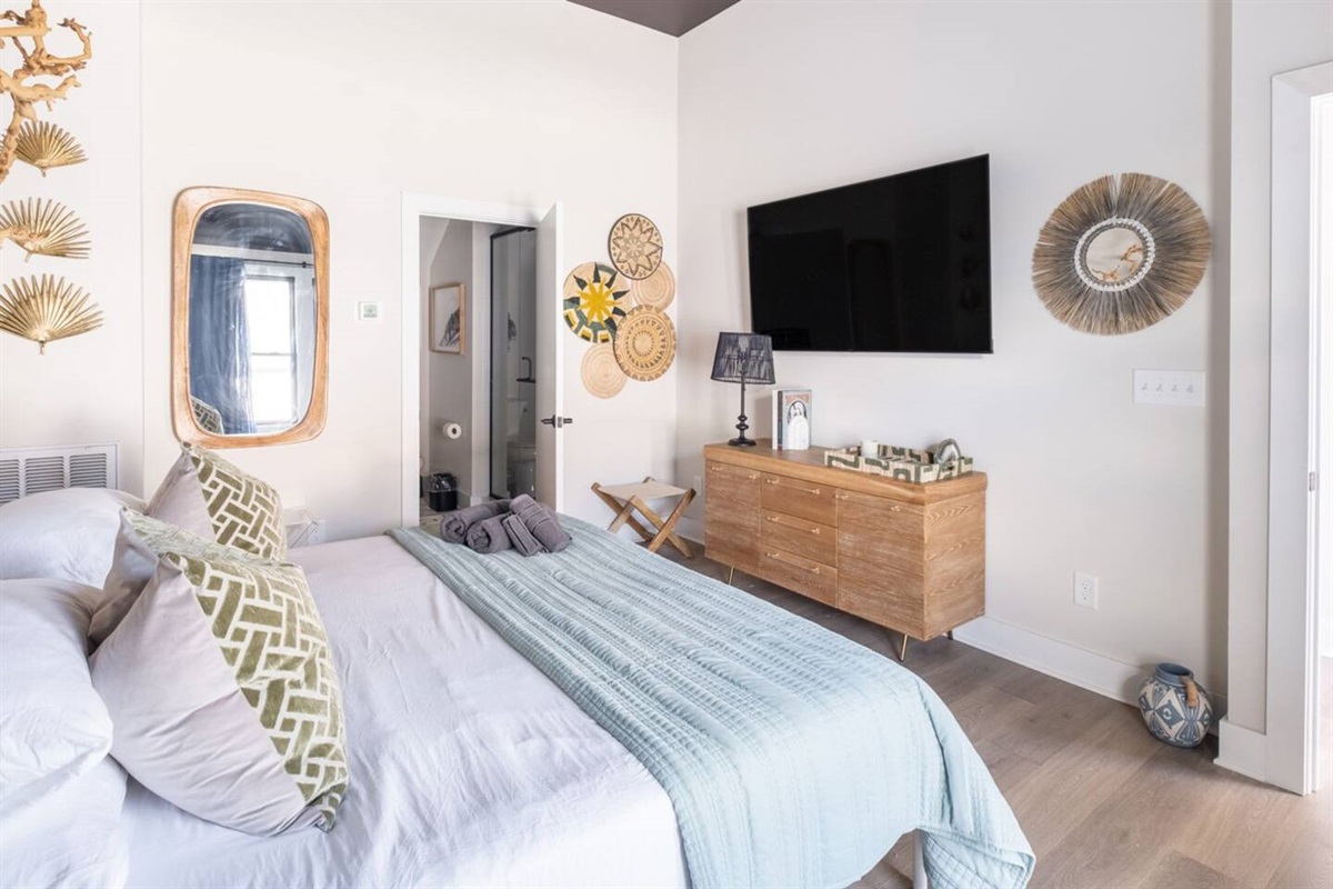 The top floor king-sized ensuite bedroom has a large smart TV loaded with all of the apps. Exquisite design is the cherry on-top! 