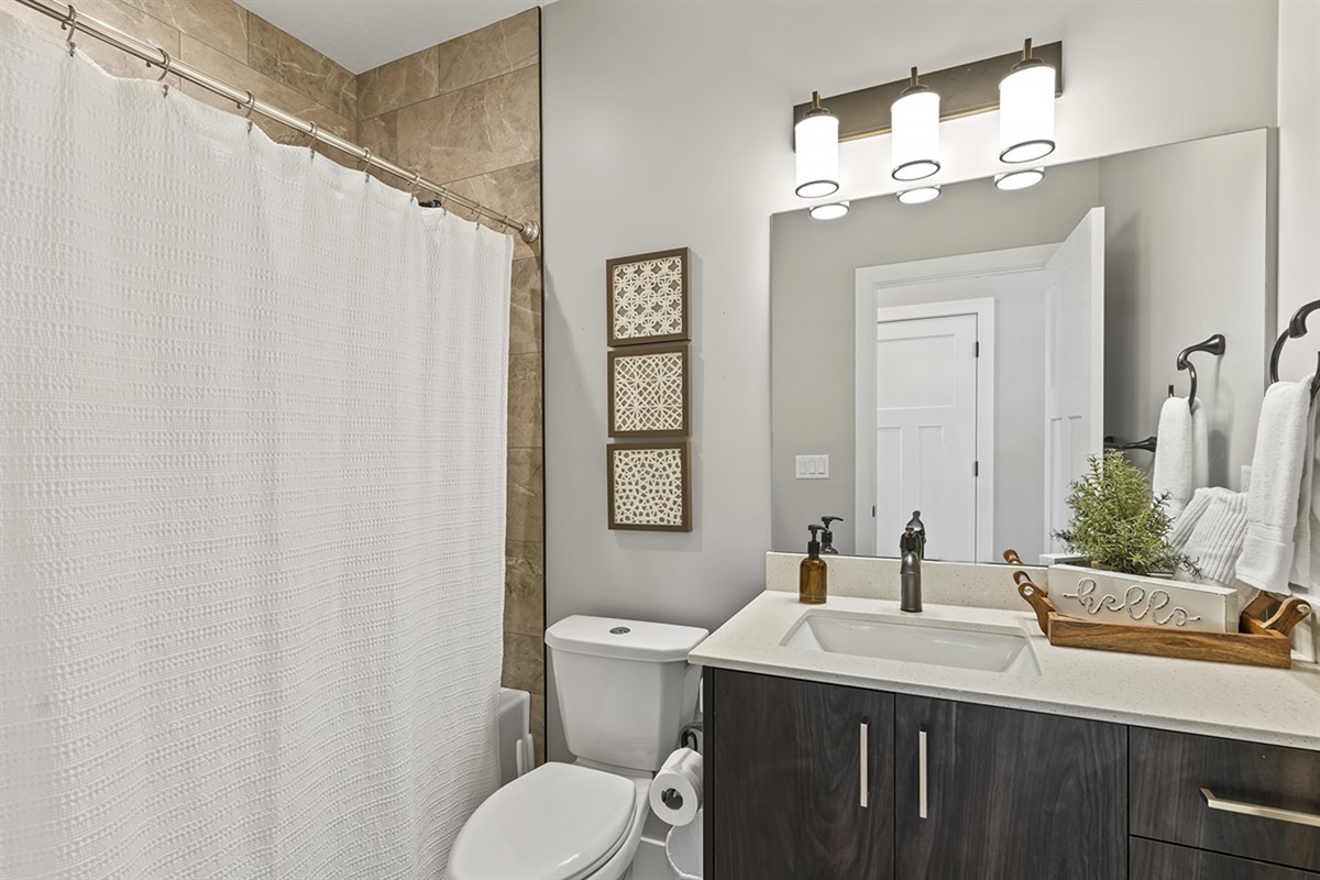 Full bathroom with shower and clean, modern finishes