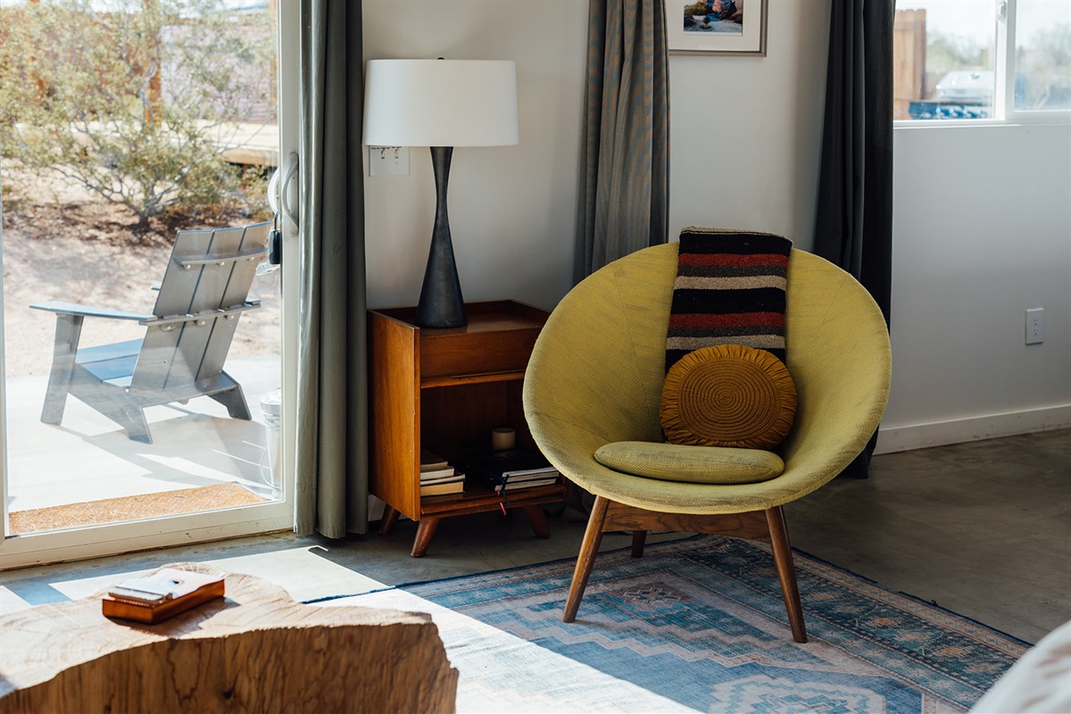 Design details in the living room with rustic wood accents, open shelving, and curated desert-inspired decor.