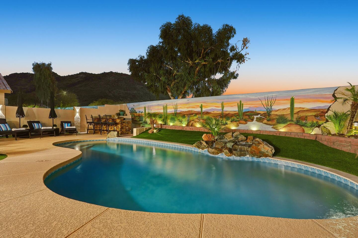 Private backyard unheated pool with lounge seating, mountain views, and a colorful desert mural for a standout outdoor retreat.