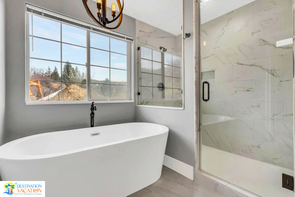 Luxurious bathroom with stunning mountain views and soaking tub.
