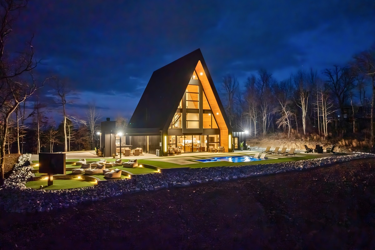The cabin looks absolutely gorgeous at night, glowing warmly and creating the perfect cozy vibe for evenings spent outside.