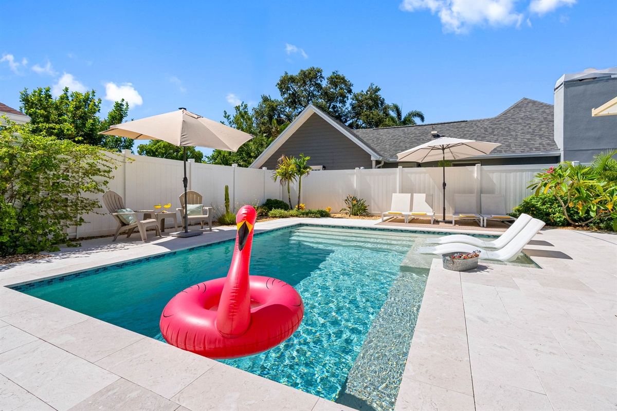 Kick back on a comfy lounger or float the day away—this backyard is built for fun and relaxation.