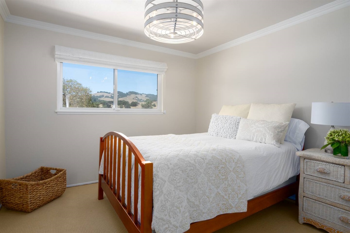 Enjoy a queen-size bed complemented by stylish architectural ceiling fans.