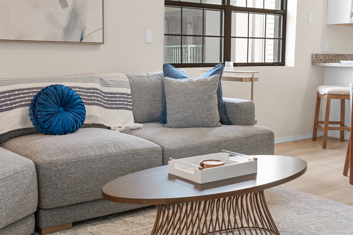 🛋 Sink into plush cushions on the oversized sectional—perfect for watching a movie, reading, or napping in natural light.