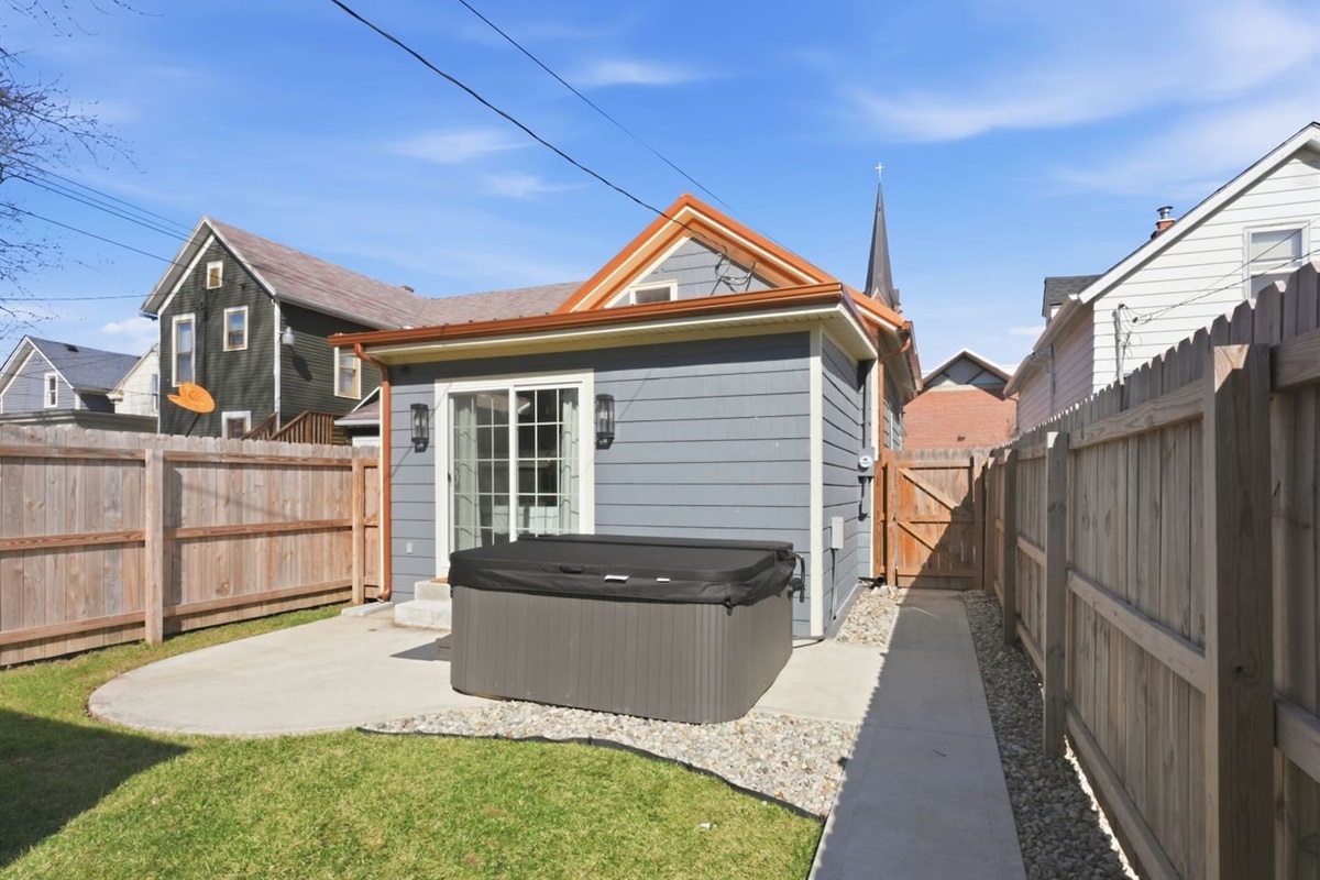 Private backyard retreat with hot tub, offering comfort, space, and a peaceful setting