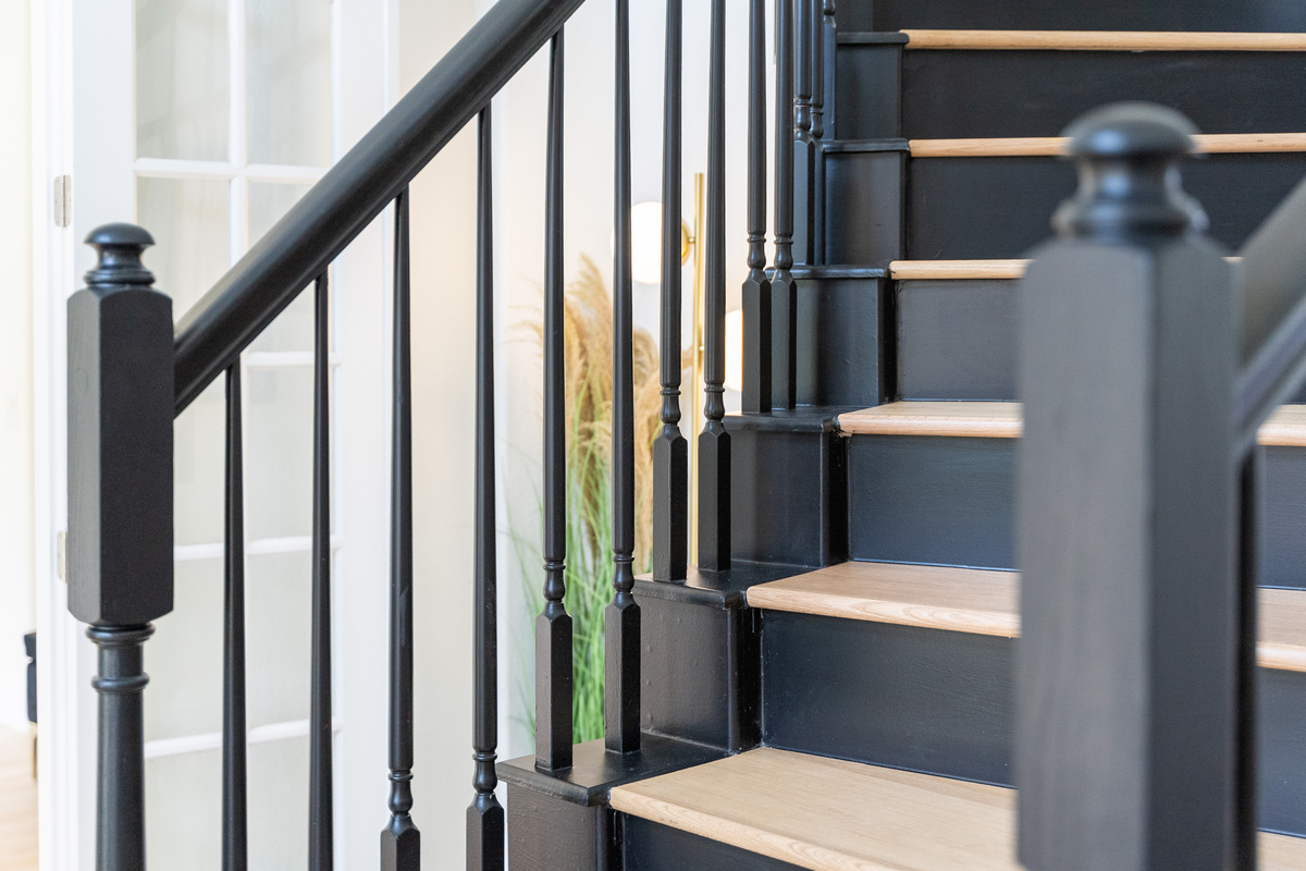 Sleek black railings and warm wood treads — modern staircase design done right.