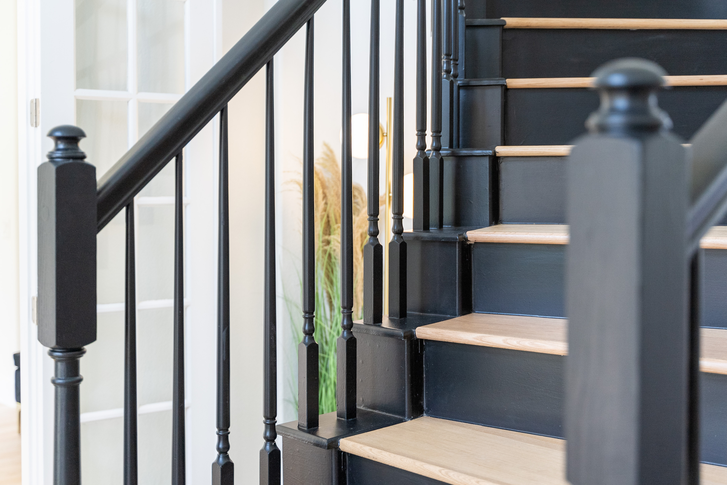 Sleek black railings and warm wood treads — modern staircase design done right.