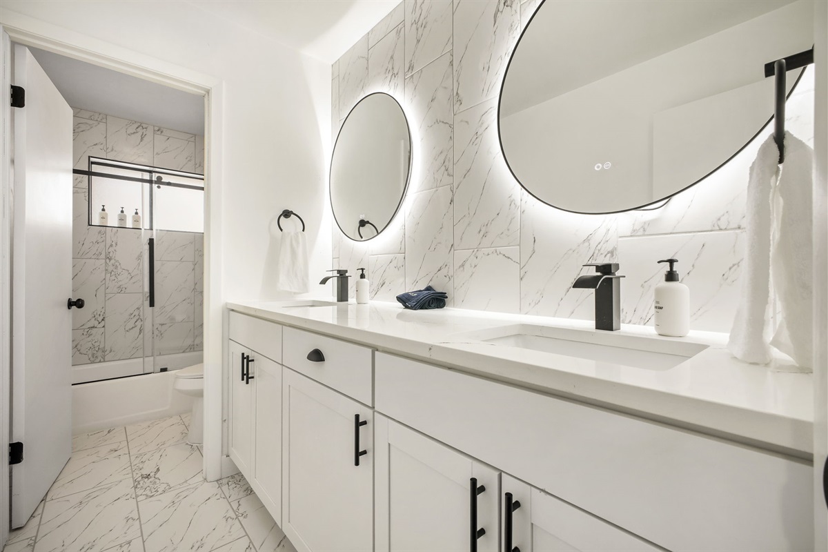 This bright upstairs bathroom is shared by the bedrooms & features spacious dual vanity, full-size tub, and shower. It’s clean, modern, & practical space designed for comfort & convenience.