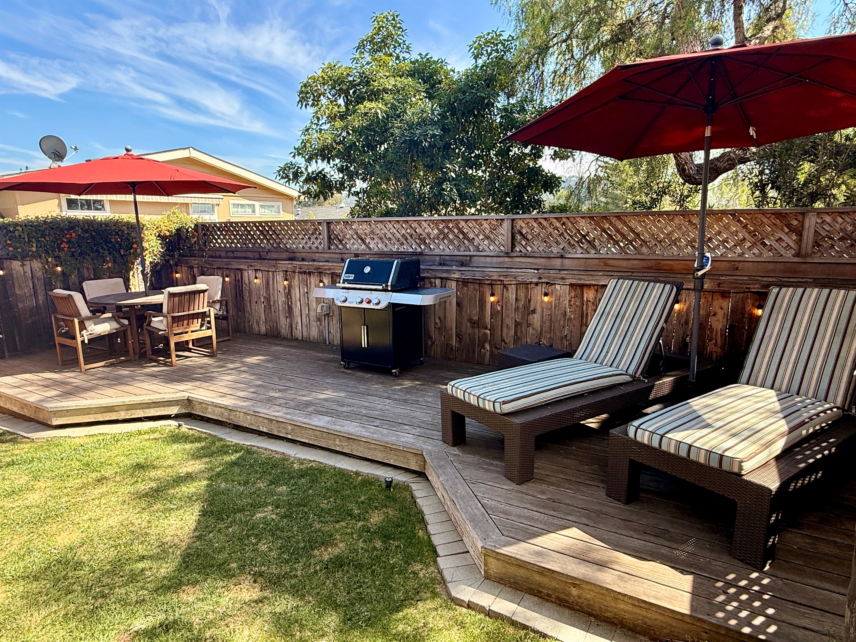 Outdoor deck includes BBQ with tools, 2 chaise lounge chairs, a dining table with 4 chairs, and 2 camping rocker chairs (stored in garage).