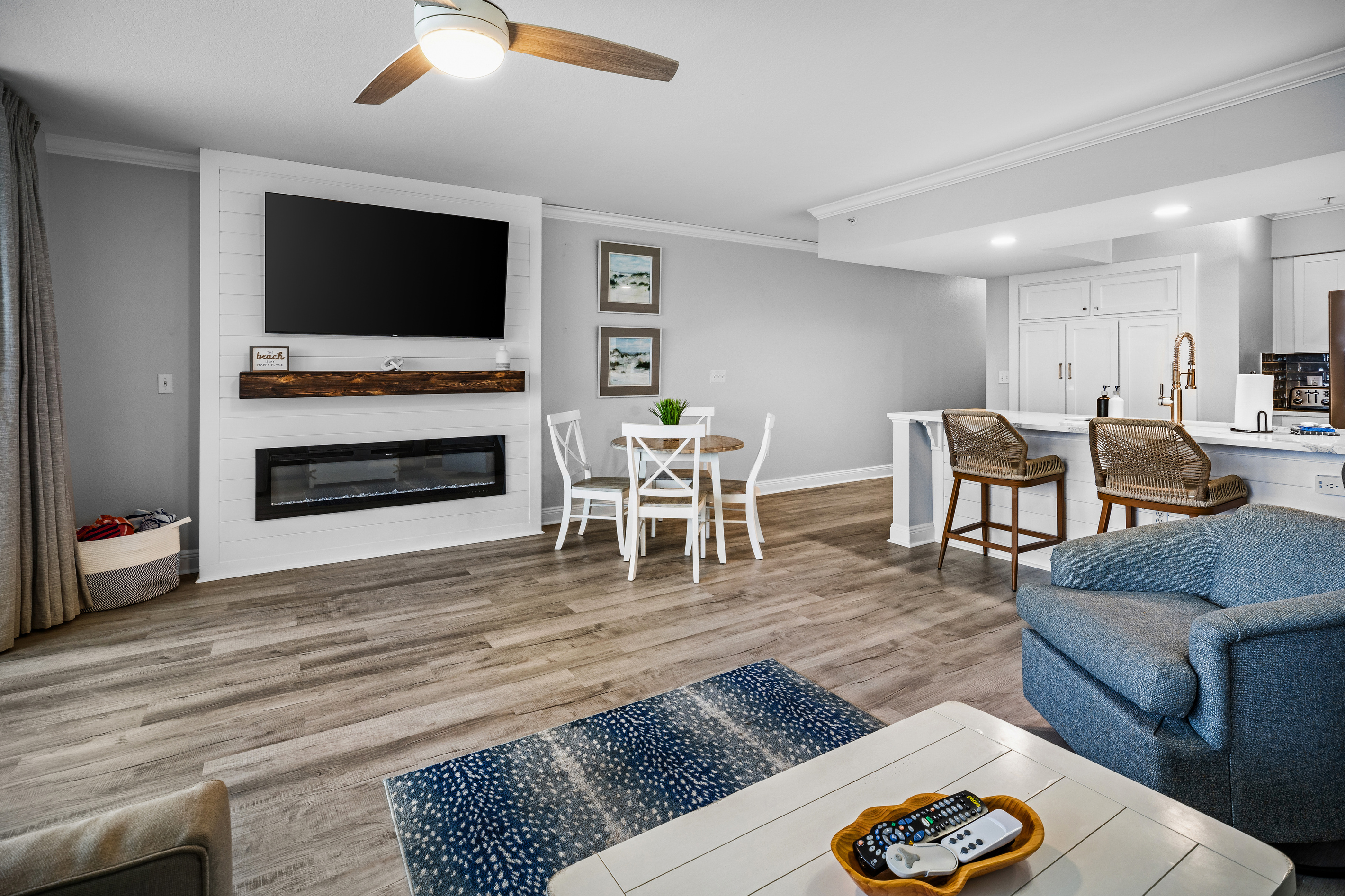 Relax in this bright open living space with coastal décor, comfy seating, smart TV, electric fireplace, and dining area, perfect for unwinding after a day on PCB. Steps from the balcony and Gulf views, it’s your ideal home base for a beach getaway. 🌊🏖️