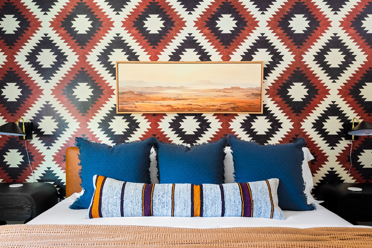 Primary bedroom with a king bed, bold decor, and cozy pillows for a restful stay.