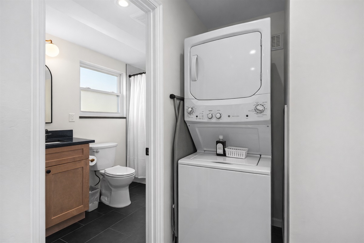 Convenient in-unit laundry beside a clean, modern bathroom—making longer stays easy, comfortable, and stress-free.