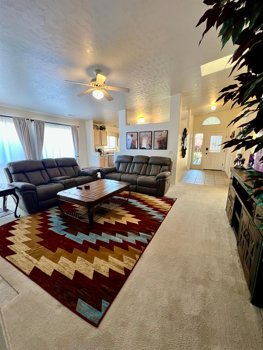The home's open floor plan seamlessly connects the kitchen, living room, and dining room, creating a spacious and airy feel perfect for entertaining and spending time together.
