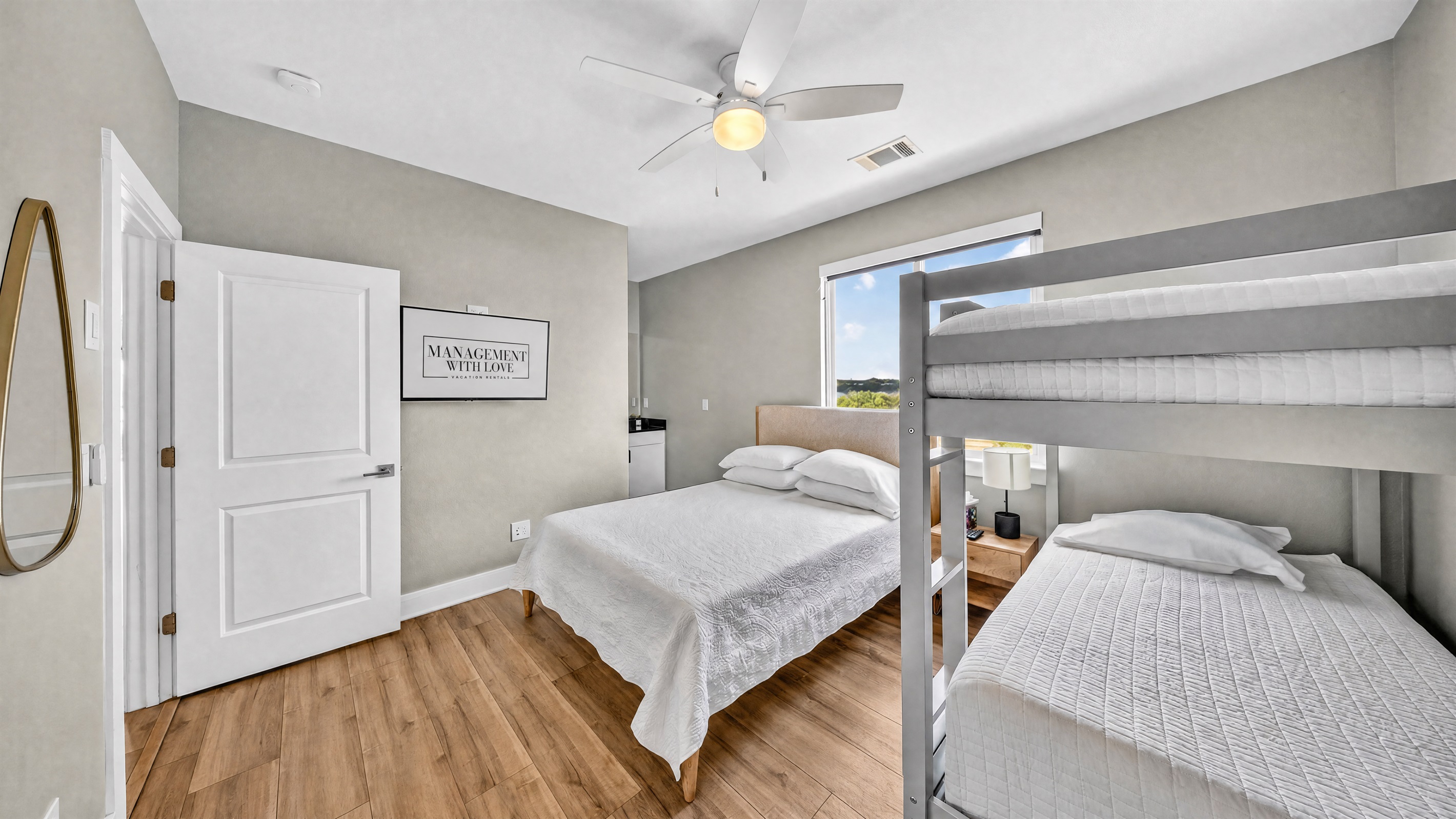 - Guest room with queen bed and bunks offers comfort for families - Soft carpet and bright natural light create a relaxing, restful stay - Functional layout supports groups enjoying a peaceful lake getaway