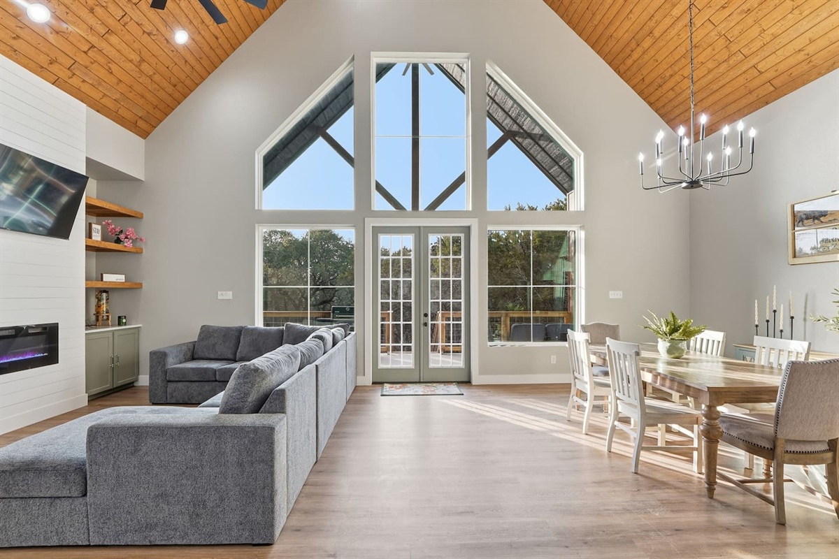 Vaulted ceilings, Oversized sectional seating, shiplap and a fire place create a gathering space at the heart of the home.