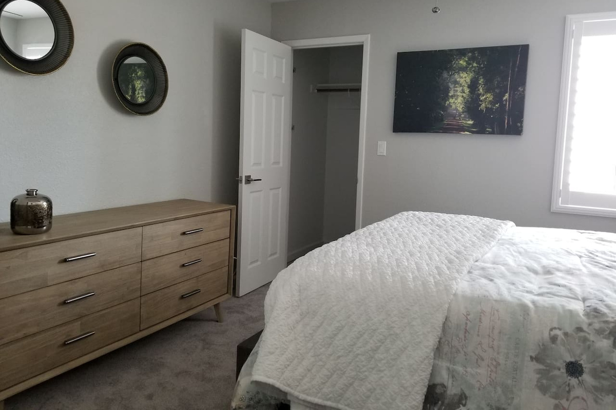 Plenty of space in this guest room. Walk in closet, plantation shutters, and comfort galore.