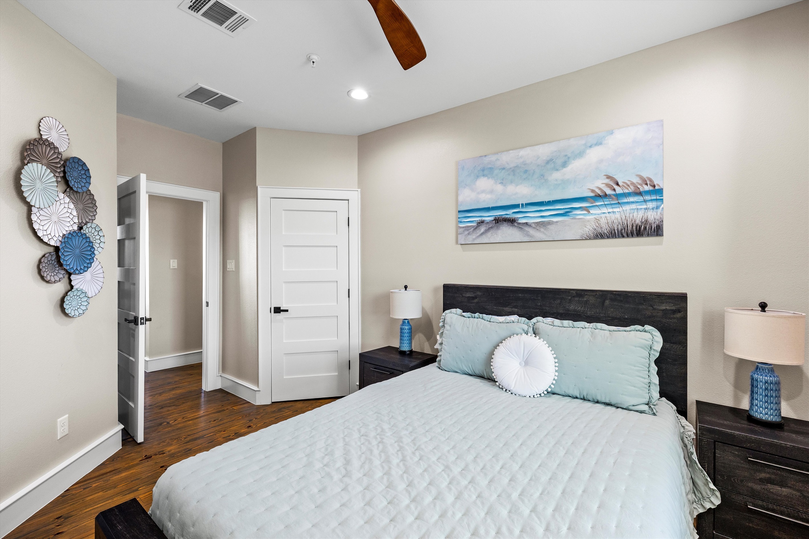 Guest Bedroom: Relax in a serene space with beach-inspired decor and inviting natural light!