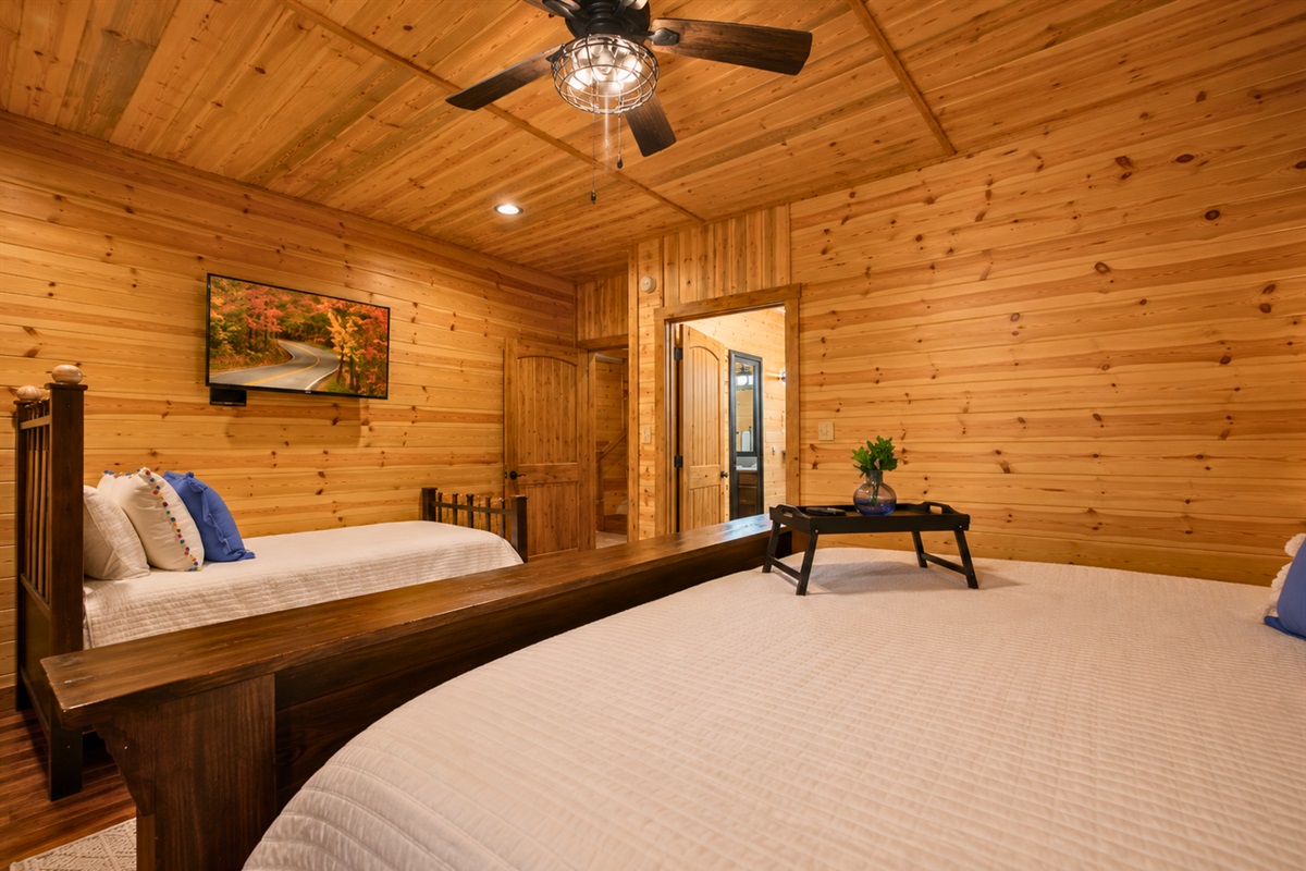 From another angle, the spacious layout highlights the cozy atmosphere and warm finishes throughout the room.