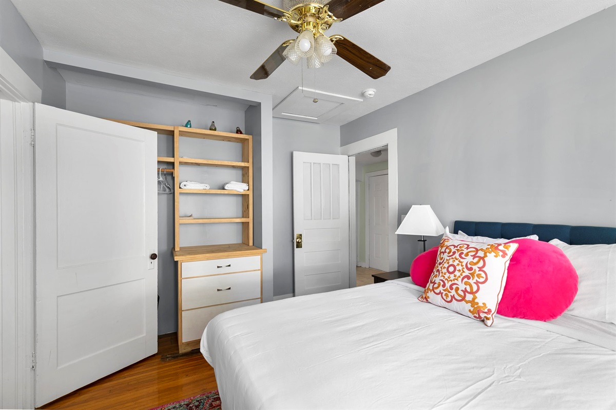Settle into a cozy queen bedroom with soft lighting and a calm, inviting feel