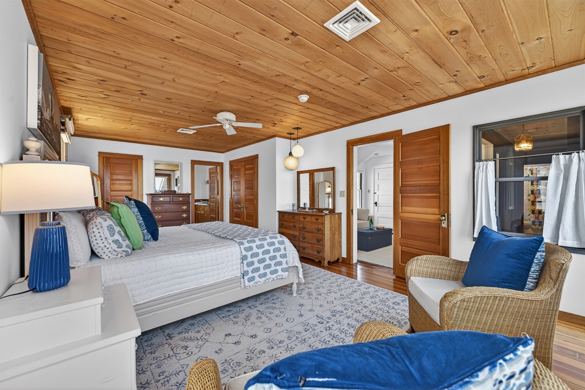 This is the other side of the first bedroom, featuring a cozy queen-size bed and access to a charming little deck!