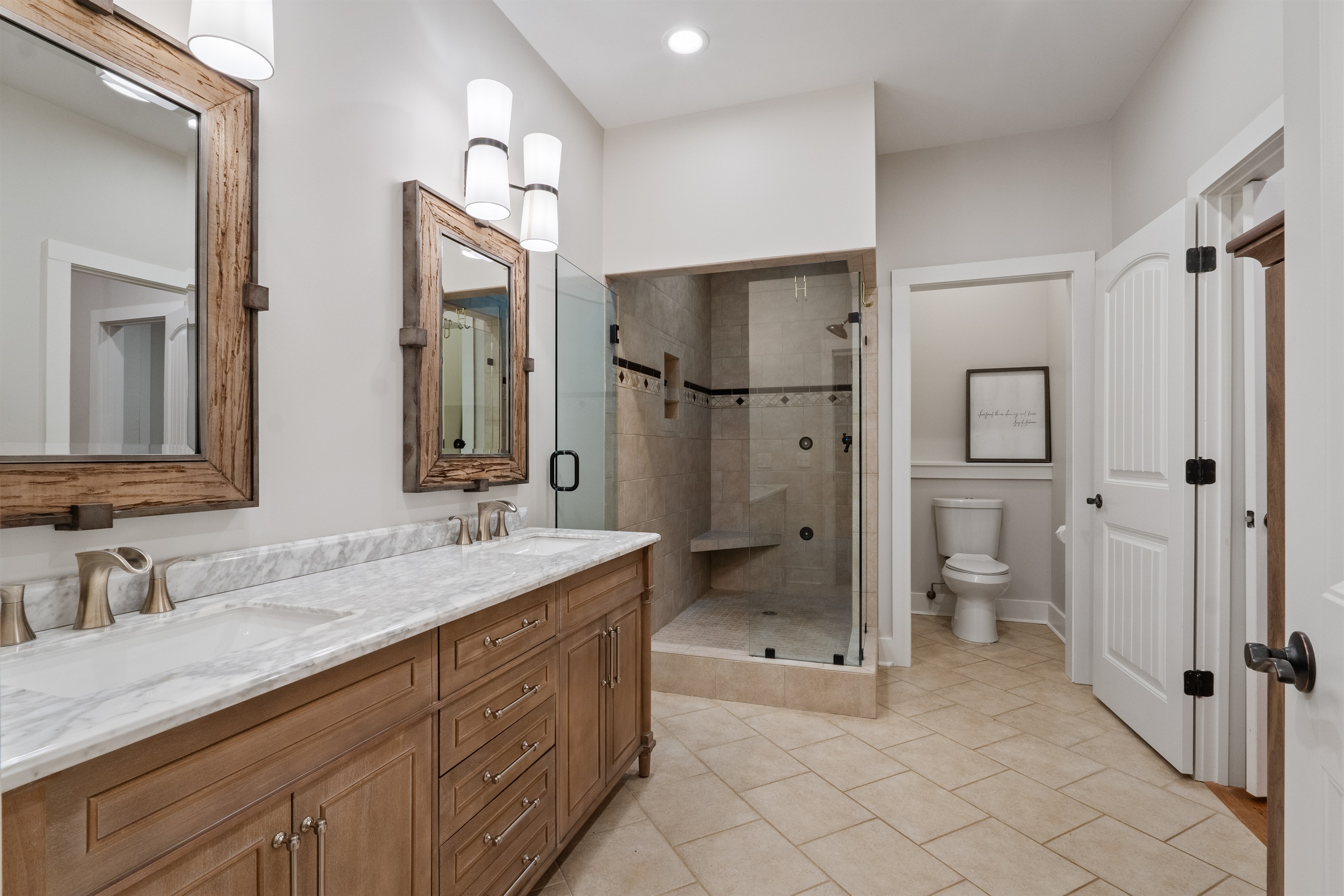The master en suite includes a double vanity and a large walk-in shower, offering both style and comfort in a spa-like setting.