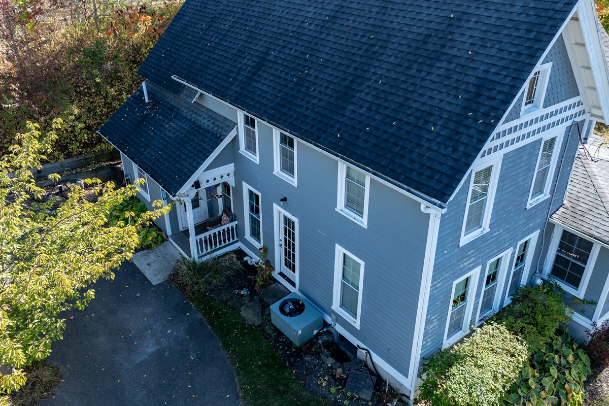 A stunning aerial view showcasing the home’s classic design and unbeatable location near the lake