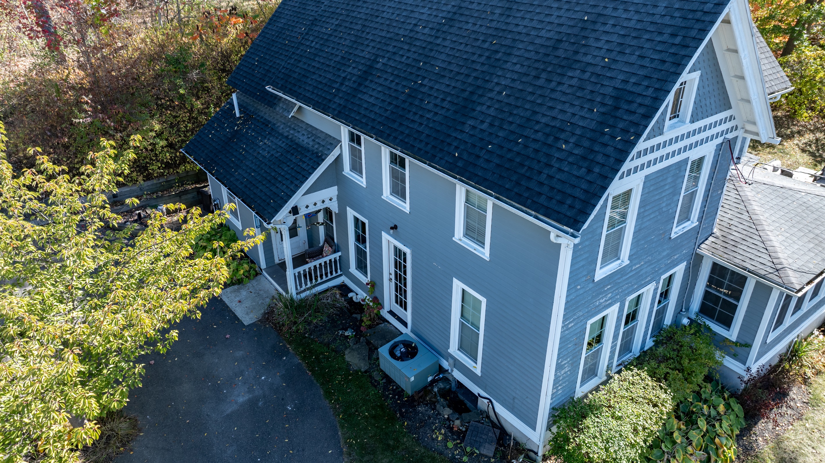 A stunning aerial view showcasing the home’s classic design and unbeatable location near the lake