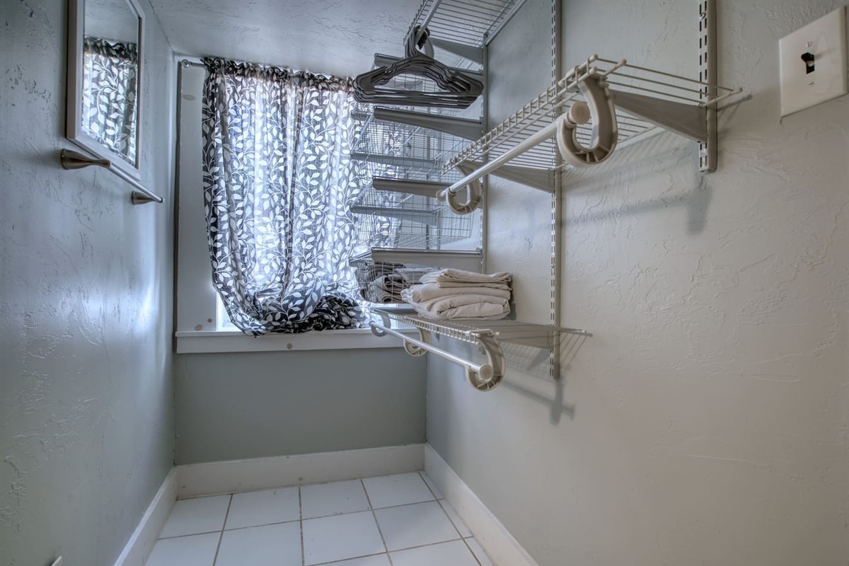 Bathroom designed with comfort in mind, featuring ample storage and hanging space.