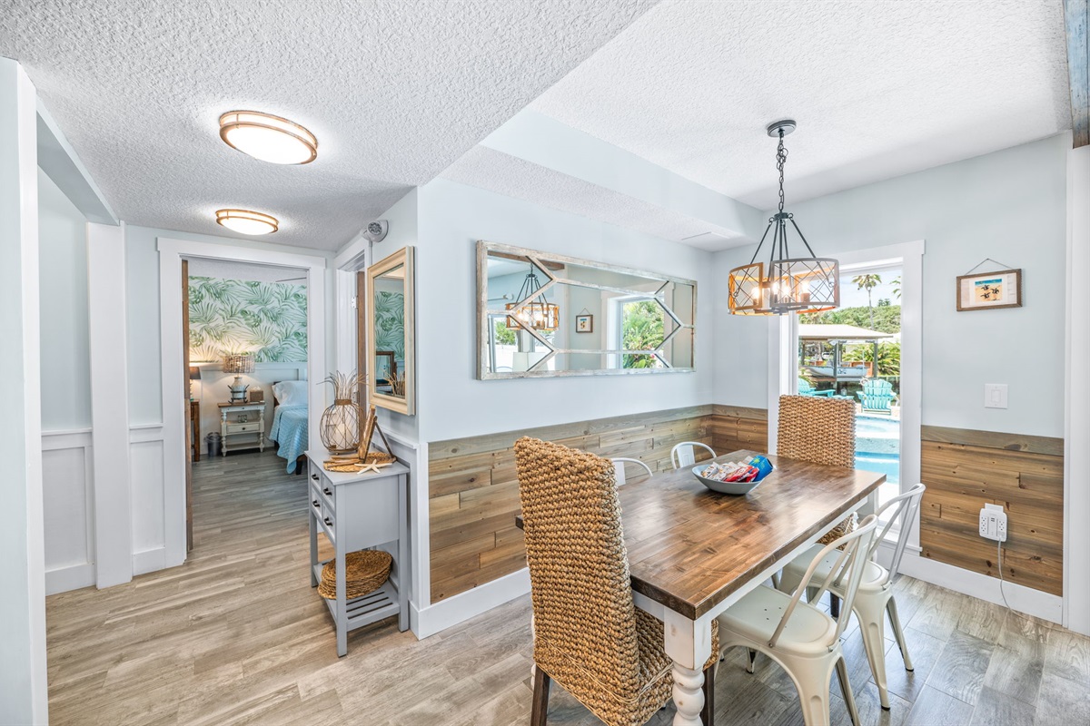 Indoor dining and peek into first floor king bedroom. 