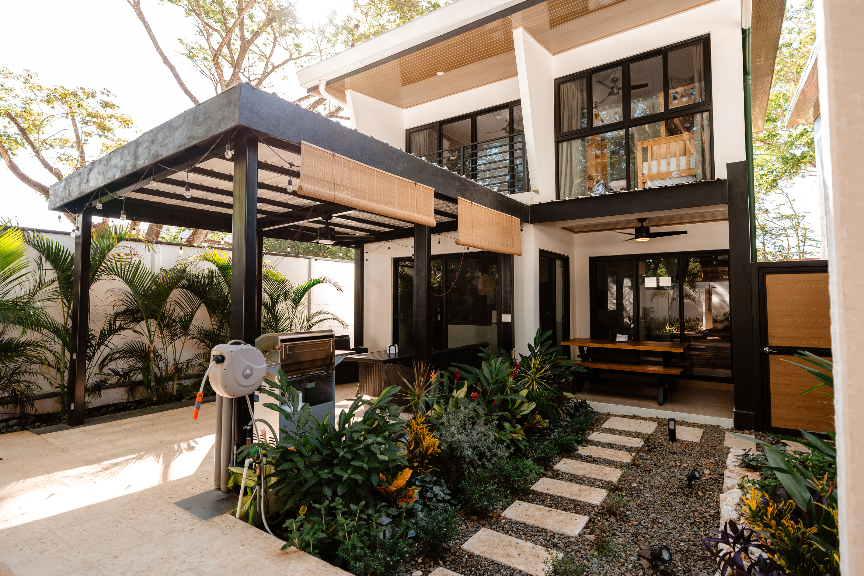 From the loungers, looking back at Casa Brisa. Terrace, gas grill, dining bench.