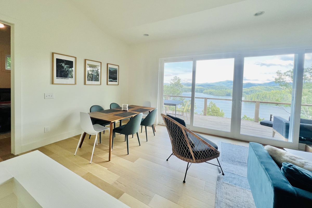 The heart of the home.
The open-concept living and dining area is filled with natural light and framed by stunning lake and mountain views. Gather for meals, relax with loved ones, or simply enjoy the scenery from the comfort of indoors.