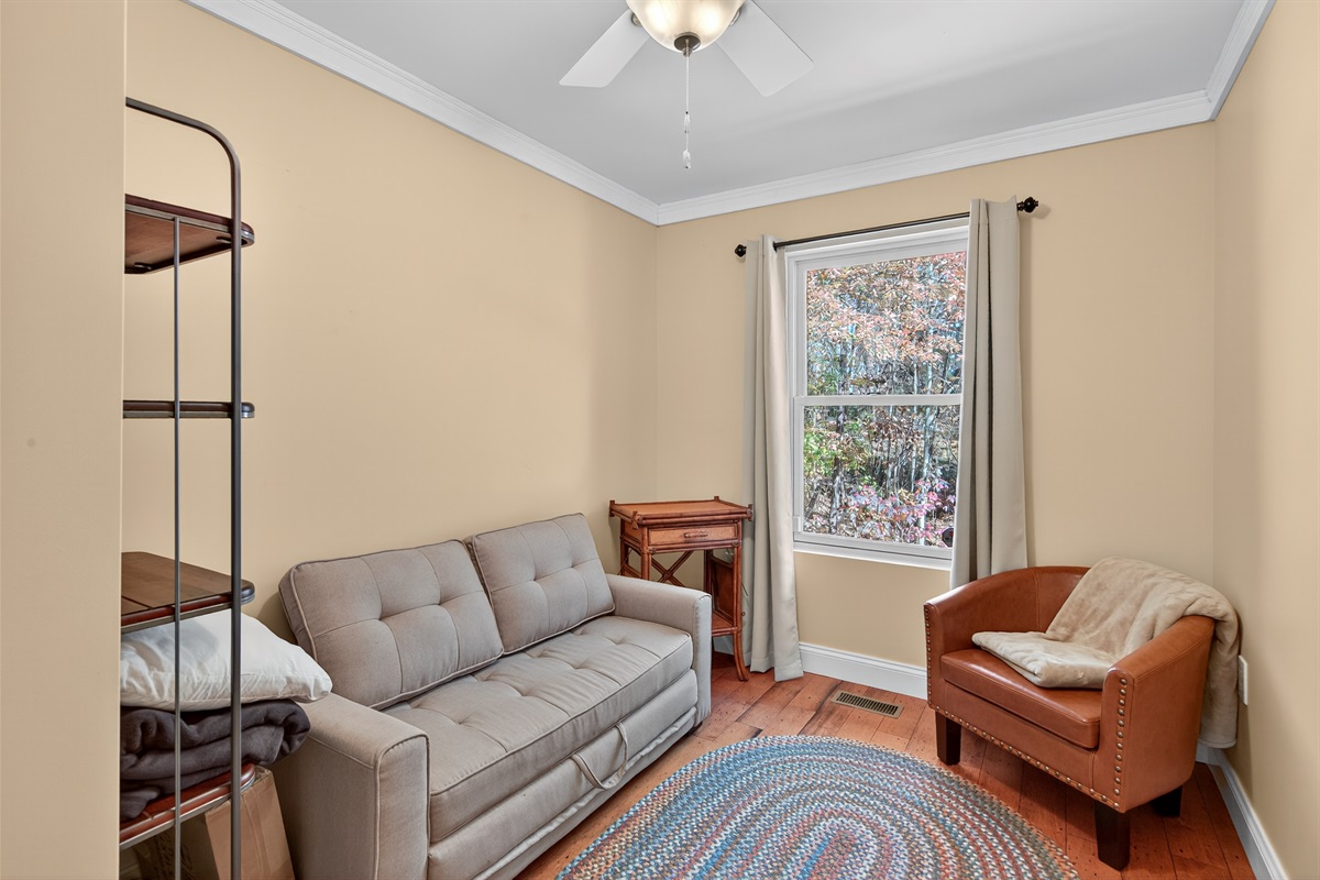 Cozy bonus room featuring a sleeper sofa and plenty of natural light—great for overflow guests.