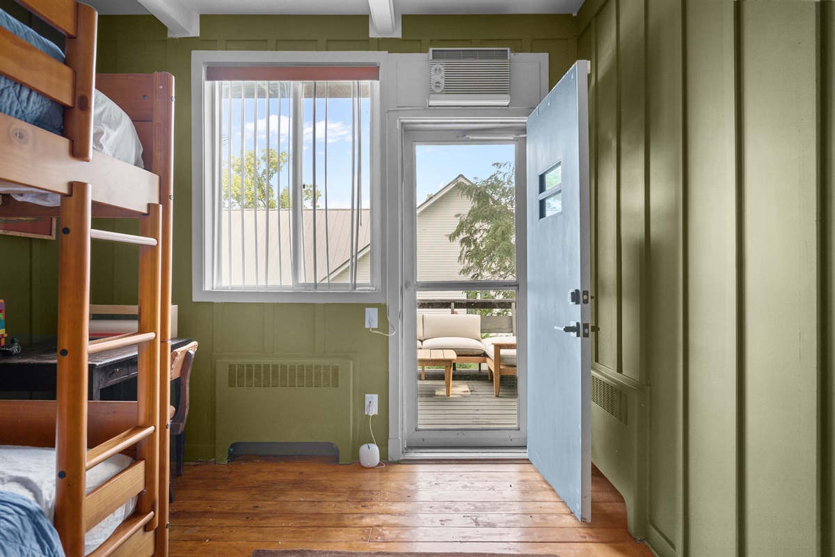 A door from the room leads directly outside to the upper balcony, making it easy to step out and enjoy fresh air and views.