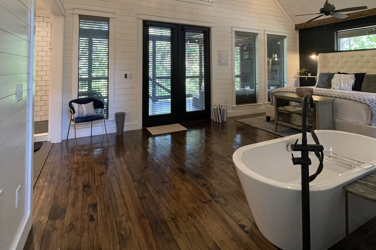 The view of the bedroom and large soaker tub from the kitchen.
