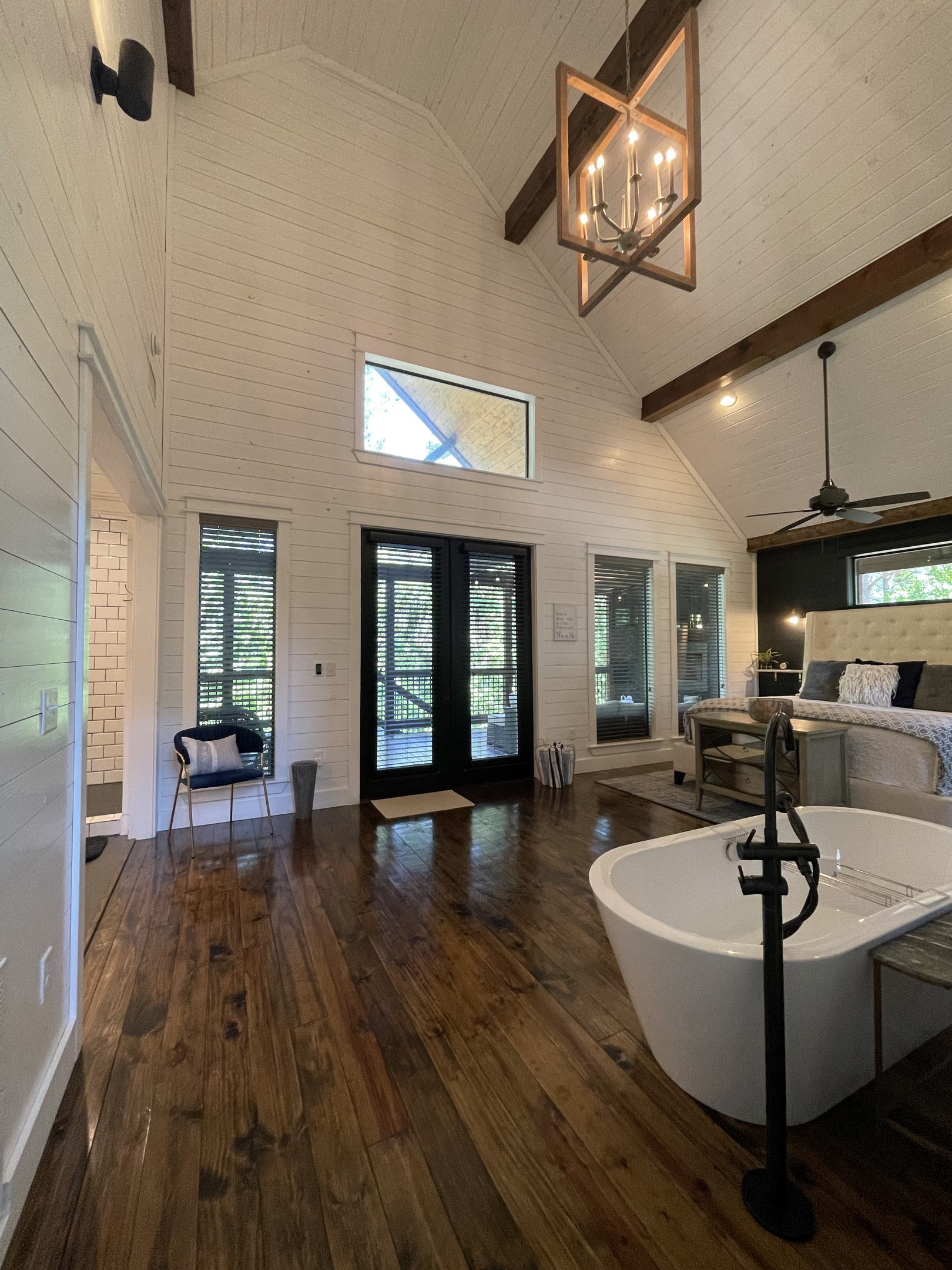 The view of the bedroom and large soaker tub from the kitchen.