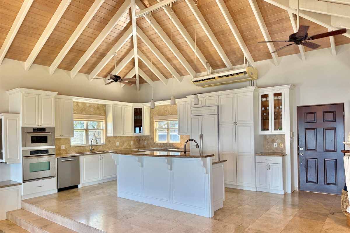 Spacious gourmet kitchen with large island, ample prep space, and everything needed to cook for a crowd.
