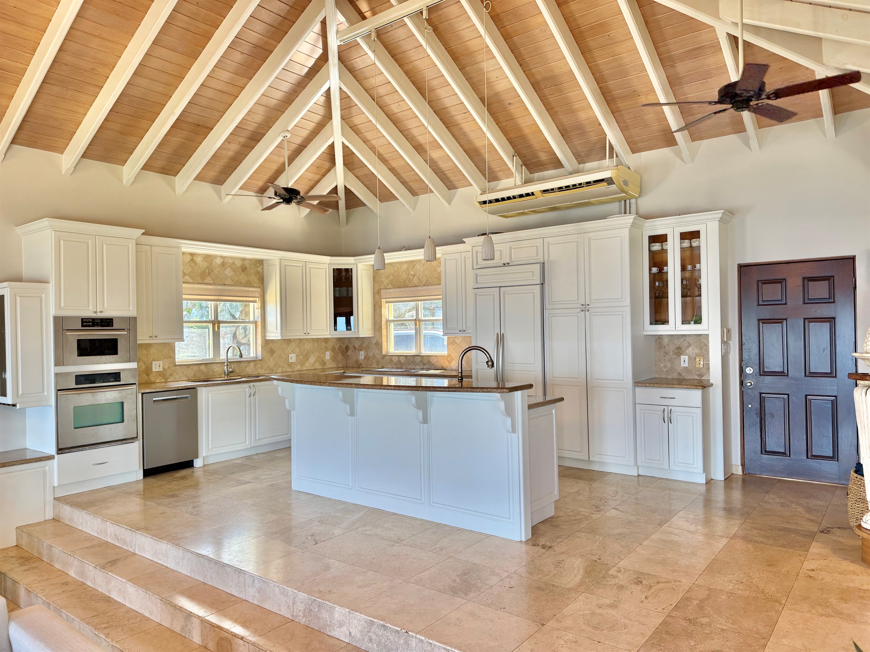 Spacious gourmet kitchen with large island, ample prep space, and everything needed to cook for a crowd.