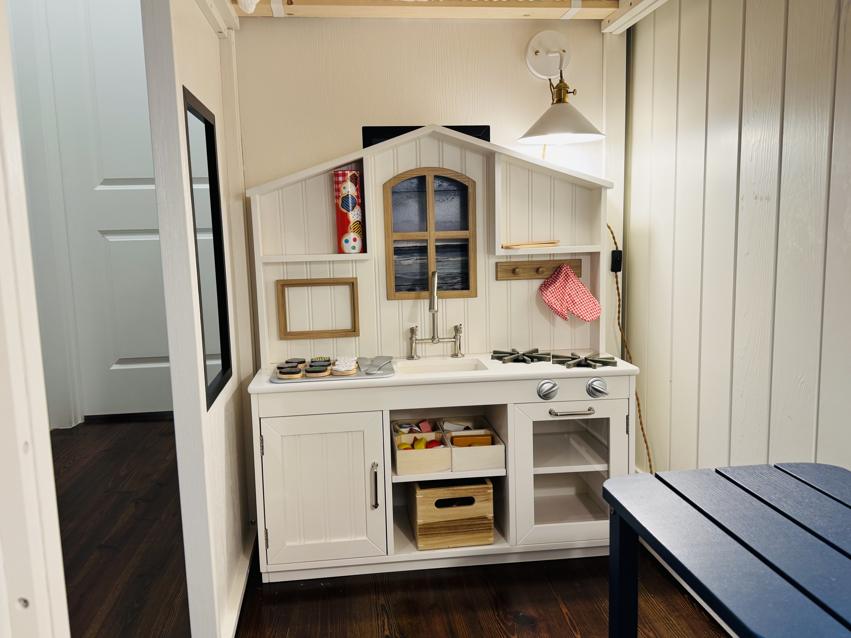 **Kid-sized play kitchen with sink, stovetop and oven for little chefs.**
