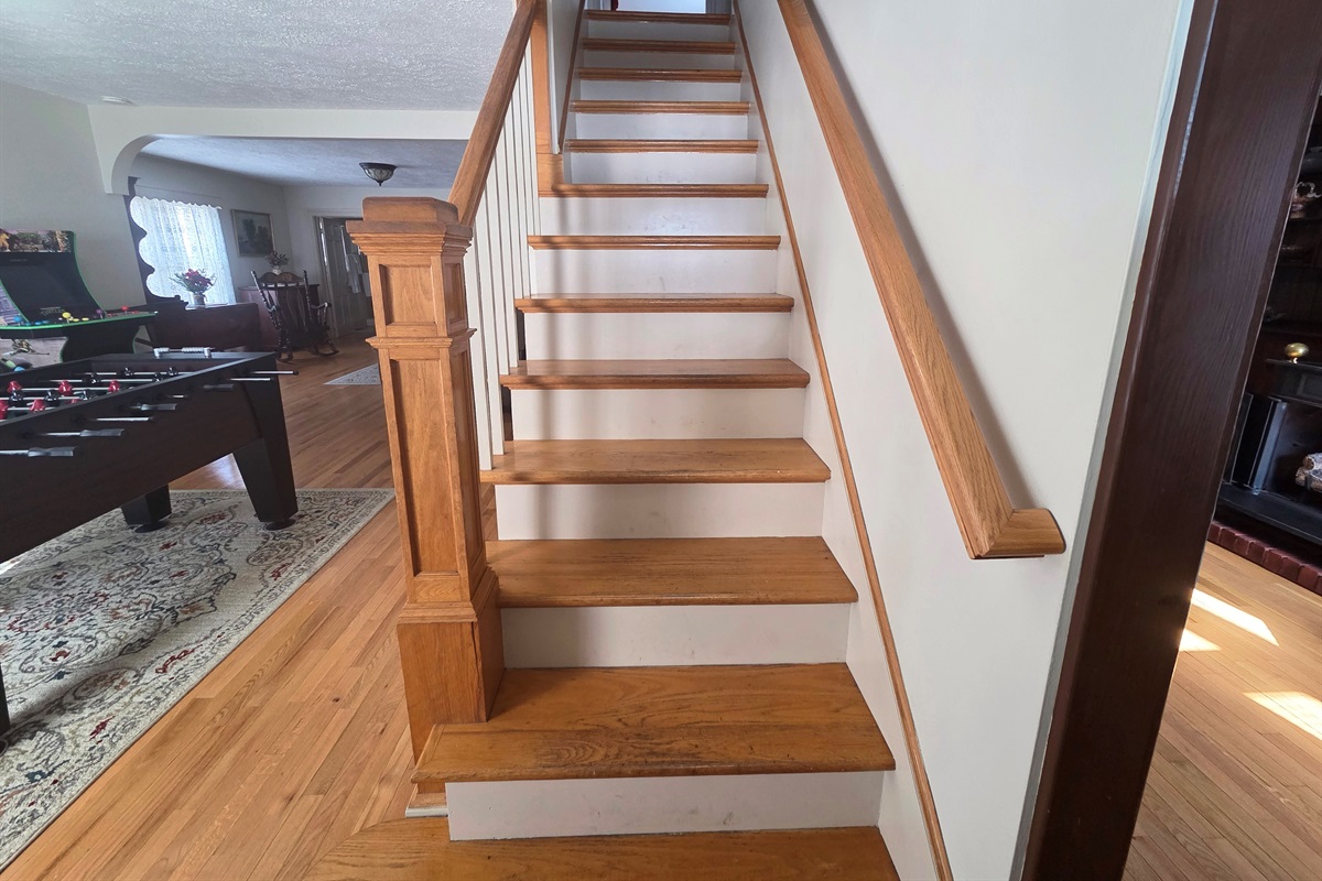 A set of steps inside the house leads to the upstairs bedrooms and bathrooms, adding to the home’s cozy