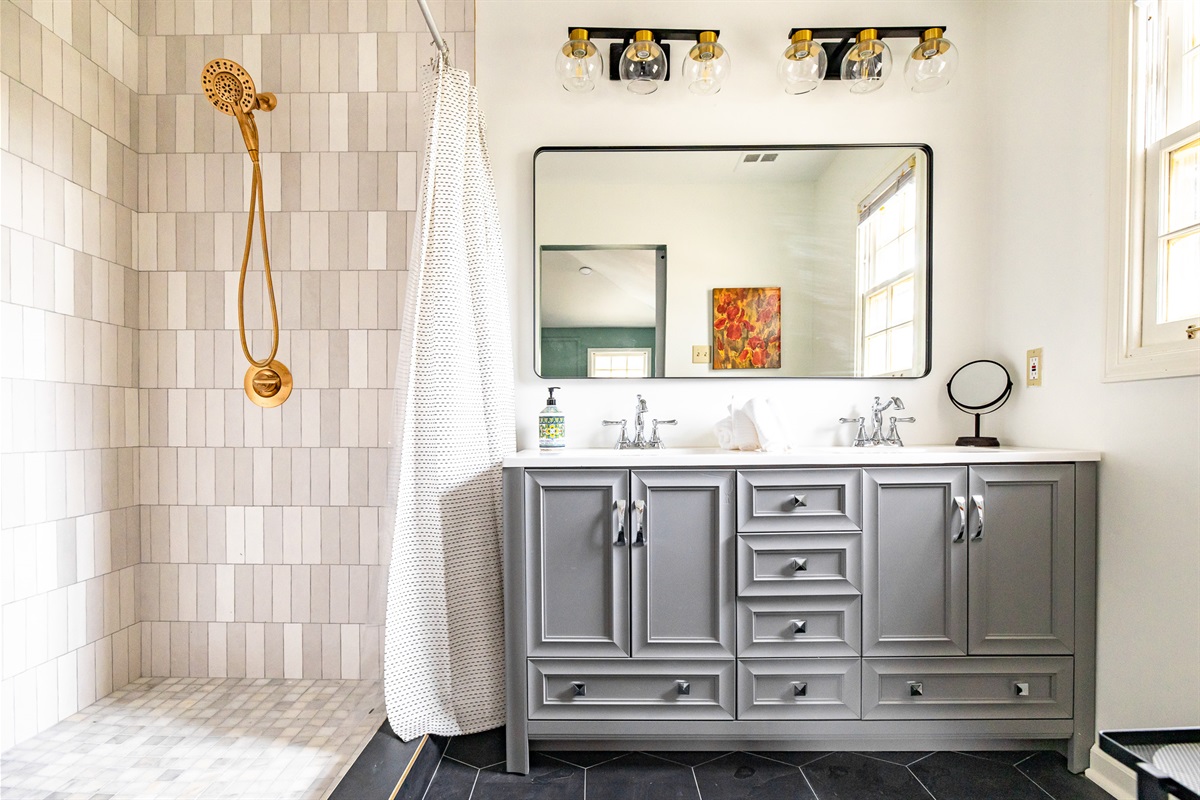 Newly renovated master bathroom with a double vanity and large walk-in shower.