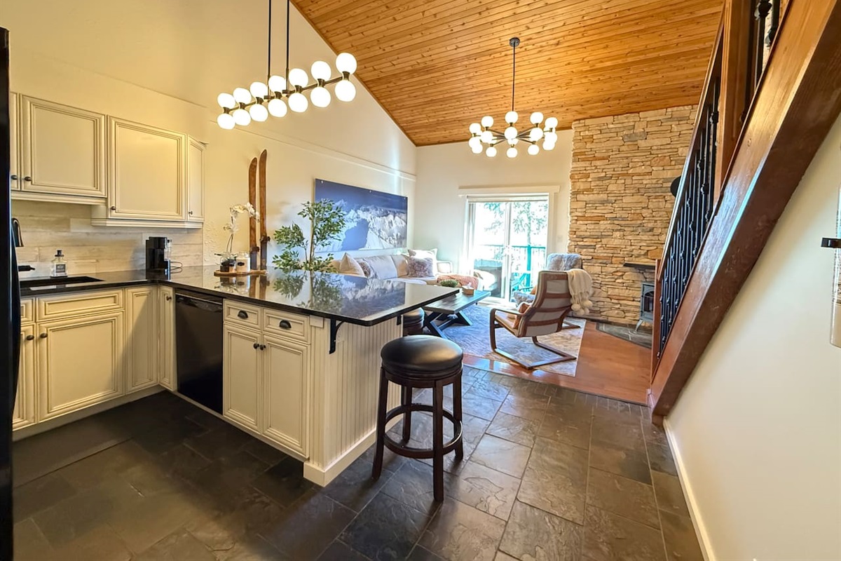 Modern Kitchen: An open-concept kitchen equipped with full-size Whirlpool appliances and a quiet Bosch dishwasher for a seamless cooking experience in your mountain getaway.